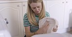 Woman, laundry and washing machine during routine wash, clean and housework at home. Housekeeper or maid cleaning and house maintenance for personal hygiene with household appliance and dryer
