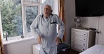 Exercise, stretching and mobility with a senior man in his retirement home, staying active for health.  Fitness, workout and training with a mature male exercising in his house for a health lifestyle