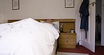 Elderly man, sleeping and wake up in bed of retirement home with morning alarm clock, lying in blanket and asleep. Retired senior person, old age home bedroom and waking up, sleepy and tired in house
