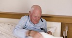 Wake up, alarm and watch with a senior man in the bed of a bedroom in a retirement home for assisted living. Time, morning and rest with a mature male patient awake in a frail care facility