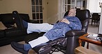 Physiotherapy, rehabilitation and blood flow with a senior man rotating his ankle in the living room of a retirement home. Exercise. health and recovery with a mature male pensioner in his house
