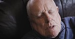 Senior man, fever and cold with a blanket to stay warm with flu, covid or pneumonia on sofa struggling to sleep with insomnia and fatigue. Elderly person on couch to rest and relax with covid 19