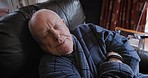 Senior man, lazy and relax, sleeping on a sofa in living room in retirement house. Elderly male, relaxing and sleep on a couch and enjoy the weekend with peace, quiet and rest or nap in home lounge

