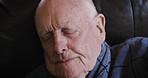 Sleep, nap and senior man on a sofa in a gown while relaxing in the living room at his home. Cold, insomnia and elderly guy in retirement sleeping for rest on a couch in his house in Australia.