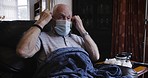 Senior man take off face mask in home to breathe after covid 19 safety, compliance and healthcare risk on living room sofa. Old man, retirement and recovery, healing and protection from corona virus 