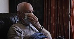 Covid, sick and senior man on the sofa for security from virus in the living room of a house. Healthcare, medical and elderly person with a face mask for danger from covid 19 in a nursing home