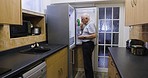 Senior man, refrigerator and open door for food choice while thinking, eating and hungry in home kitchen. Elderly person at fridge to prepare meal, lunch or dinner in retirement in Uk house alone