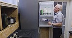 Old man, fridge and searching for food to cook a meal in his home and enjoying a retirement lifestyle. Diet, nutrition or refrigerator with an elderly male looking for food and drink for dinner 