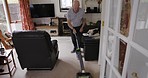 Senior man, vacuum and cleaning living room in house or home living room in hygiene maintenance of floor carpet dust. Retirement elderly, household equipment or housekeeping management for healthcare
