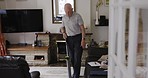 Vacuum, cleaning and senior man in home vacuuming carpet for hygiene. Spring cleaning, rehabilitation and retired elderly male from Canada in living room with machine to clean or remove dust on floor