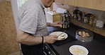 Breakfast, cooking and senior man in the kitchen for health, wellness and nutrition. Lunch, eating food and hungry elderly man with a healthy protein diet for dinner during retirement in a home