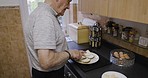 Food, bread and old man with breakfast in kitchen for healthy meal in the morning. Wellness, nutrition and retired elderly male from Canada making delicious sandwich, apply butter and cutting toast.