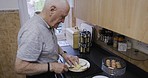 Breakfast, cooking senior and man in the kitchen, hungry sandwich and retirement diet in a house. Food wellness, healthy morning and elderly person chef with protein lunch or dinner in a home