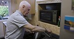 Kitchen, kettle and basin with a senior man using water to prepare a tea or coffee beverage in his home. Elderly, drink and retirement with a matire male filling a boiler in his house in the morning