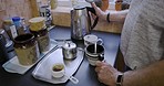 Hands, drink and man make tea in kitchen for breakfast, energy and caffeine in morning. Lifestyle, home and closeup of hand with kettle, cup or mug for hot beverage, espresso and drink in male house
