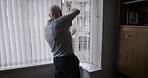 Senior man, window and hand wave to greet neighbor or person and opening blinds for light in morning during retirement at home. Old person waving in UK house for respect and kindness in neighborhood