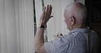 Senior man, window and waving hand while opening blinds to greet a neighbor or person with hello in morning during retirement. Elderly man in his Uk house to doing wave for kindness or goodbye