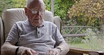Senior man reading, glasses and book while relax, story or novel on sofa, retirement and retired life in home. Elderly male read, relaxing and sitting on couch, pensioner and eyewear for vision