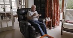 Senior man, sofa or plate with sandwhich for lunch, breakfast or dinner in home living room for tv. Elderly male, relax and eating with bread, coffee or tea in on couch, chair or lounge in London
