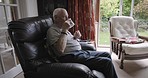Old man, drinking tea while relax in a chair in his home for health and wellness. Coffee, drink and senior male in retirement home relaxing with a delicious hot beverage for a calm and peaceful break