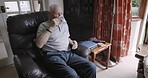 Coffee, relax and senior man thinking of retirement in the living room of his house. Peace, calm and elderly man with an idea, tea drink and in a chair in the lounge for stress relief and relaxation