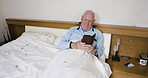 Senior man, phone and relax in bedroom internet browsing, on social media or texting. Retirement, tech and elderly male from Canada in home with mobile smartphone typing, web scrolling or networking.