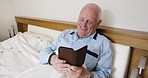 Senior man, phone and smile for social media, funny meme and relax in bed, retirement and pensioner in the morning in home. Elderly male, mobile smartphone and reading new, online message and app 