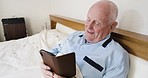 Technology, retirement and man with phone in bed reading or writing text with smile, happiness and joy. Communication, connection and happy old man checking funny message on mobile app in bedroom.