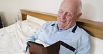 Elderly man, phone and smile for social media, texting or chatting while lying on the bed at home. Happy senior male enjoying conversation, browsing or typing on mobile smartphone in the bedroom