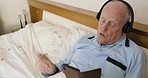Music, phone and senior man relax in bed, singing, happy and cheerful while resting and reading online lyrics. Headphones, elderly man and radio in a bedroom with smartphone texting, recovery and joy