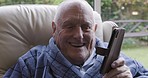 Retirement, senior and man on speaker phone in home for positive communication, talk and news. Happy, relax and elderly person on pension speaking on smartphone microphone with good update.

