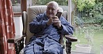 Elderly man, smartphone conversation and relax in armchair of retirement home using wifi network connection for global communication. Cellphone call, talking online and peace in living room of house 