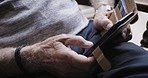 Hands, senior man and wifi texting with a smartphone or browsing online for news. Cellphone, chatting and hand of retired male searching the internet for closeup communication with a contact