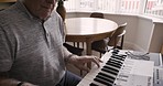 Senior man, piano and playing notes, music or training with progress, relax or stress relief. Mature pianist, happy elderly male or calm in lounge, touch black and white keys for peace and retirement