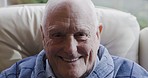 Portrait, happy and senior man on a sofa, laughing and relax in a retirement home, cheerful and content. Face, excited and elderly man enjoy retirement, peaceful space and comfort in living room