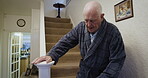 Senior man, walking or staircase in house or nursing home in surgery recovery healthcare, life insurance or medical support. Retirement elderly person, climbing steps or hand rail rehabilitation help