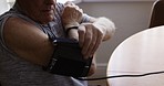 Senior man, blood pressure and measurement device on arm for health and wellness. Hypertension, retirement and elderly male from Australia with digital tech to measure heart health or pulse in home.