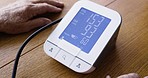 Hands, senior man and blood pressure measurement, writing results on paper for health or wellness. Retirement, hypertension and elderly male with digital tech to measure heart health or pulse in home