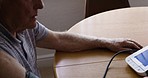 Blood pressure, healthcare and man hands checking medical, heart and digital health monitor. Medic, hypertension and test of a patient check elderly and senior nursing technology data at home