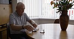 Senior, medicine and pills of a man in a retirement nursing home with mental health ill. Elderly person taking medication for dementia, depression or anxiety in old age for health and wellness 