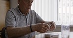 Medicine, pills and senior man in a nursing retirement home ready for healthcare medication. Pain, dementia and anxiety support tablet with elderly person and pharmaceutical drugs for arthritis