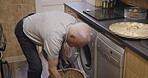 Washing machine, laundry and elderly man with clothes for cleaning, house work and hygiene for cleaning at home. Senior male with fabric to clean, home appliance and housekeeping in retirement.