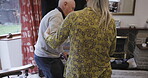 Support, care and disability with a senior couple in the living room of their home together for help or assistance. Trust, love and walking stick with a mature wife helping her husband in the house