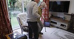 Man helping wife walk, senior care and support in rehabilitation with walking stick. Couple in retirement home together, assistance with standing up and elderly woman with face mask indoors