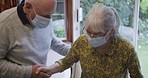 Senior care, husband helping wife stand and support in rehabilitation with walking stick. Couple in retirement home together, assistance with walking and elderly woman with face mask indoors