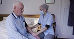 Elderly man, blood pressure and night on bed in nursing home for health, wellness or hypertension. Senior, retirement and nurse with medical machine in bedroom for help, consultation or check results