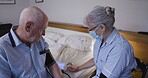 Healthcare, blood pressure or retirement with a woman nurse and a man patient in the bedroom of a home. Medical, exam and assisted living with a senior male having a checkup while sitting on the bed