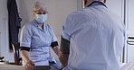 Healthcare, consultation and caregiver with a senior man checking his blood pressure in his bedroom. Homecare, medical and female nurse with a face mask consulting elderly patient at retirement home.