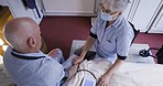 Blood pressure test, elderly patient and nurse with health, wellness and medical exam. Retirement, nursing and senior care home with caregiver helping with medic consulting and service for cardiology