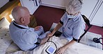 Old man with nurse, medical and blood pressure check with machine, retirement and nursing home top view. Health, wellness and aging with cardiovascular healthcare, woman in face mask and caregiver